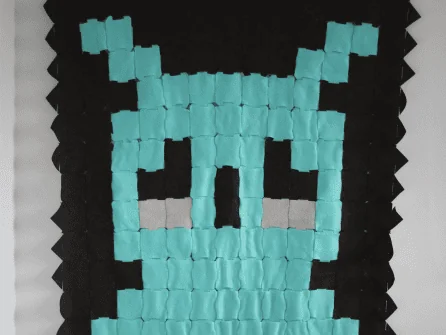 Custom interlocking tile owl installation on a wall