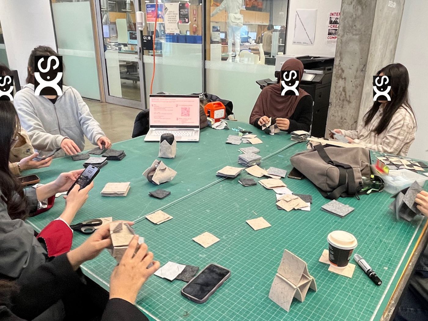 A group gathered around a table making with tiles at Monash University