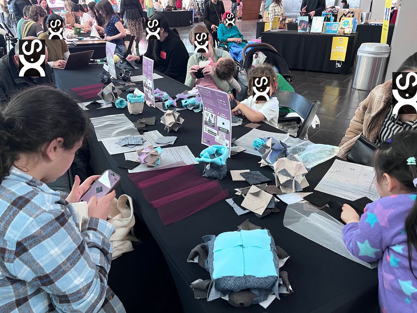 Families and children making tile pieces at the 2026 Zero Waste Festival